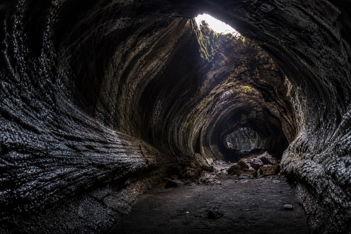 Inside a lava tube carved by an old flow, a stop on some hiking routes on Etna