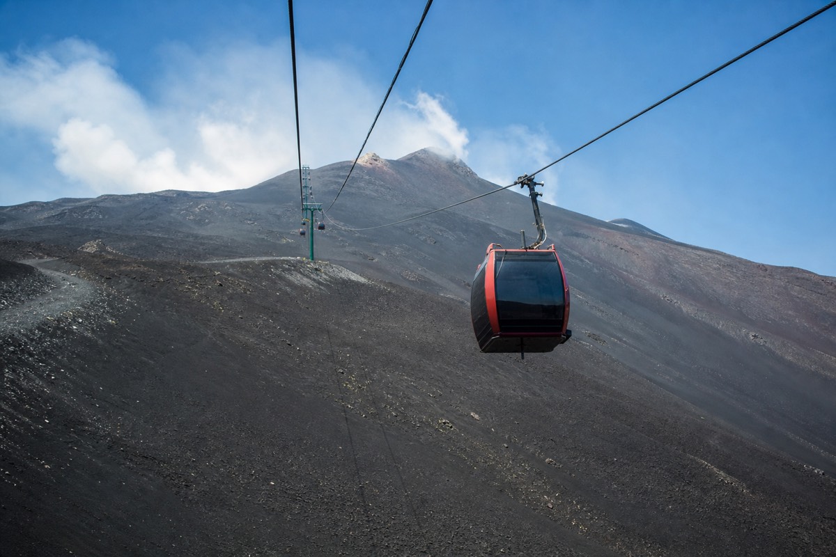 Visiting Mount Etna independently, you can ride the Funivia cable car up from Rifugio Sapienza toward the summit area