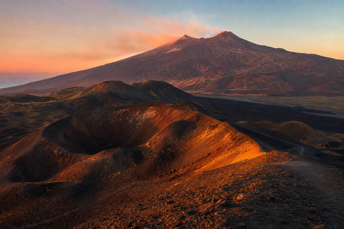 Golden hour light on the volcanic ridges visible when exploring Mount Etna without a tour from the access road